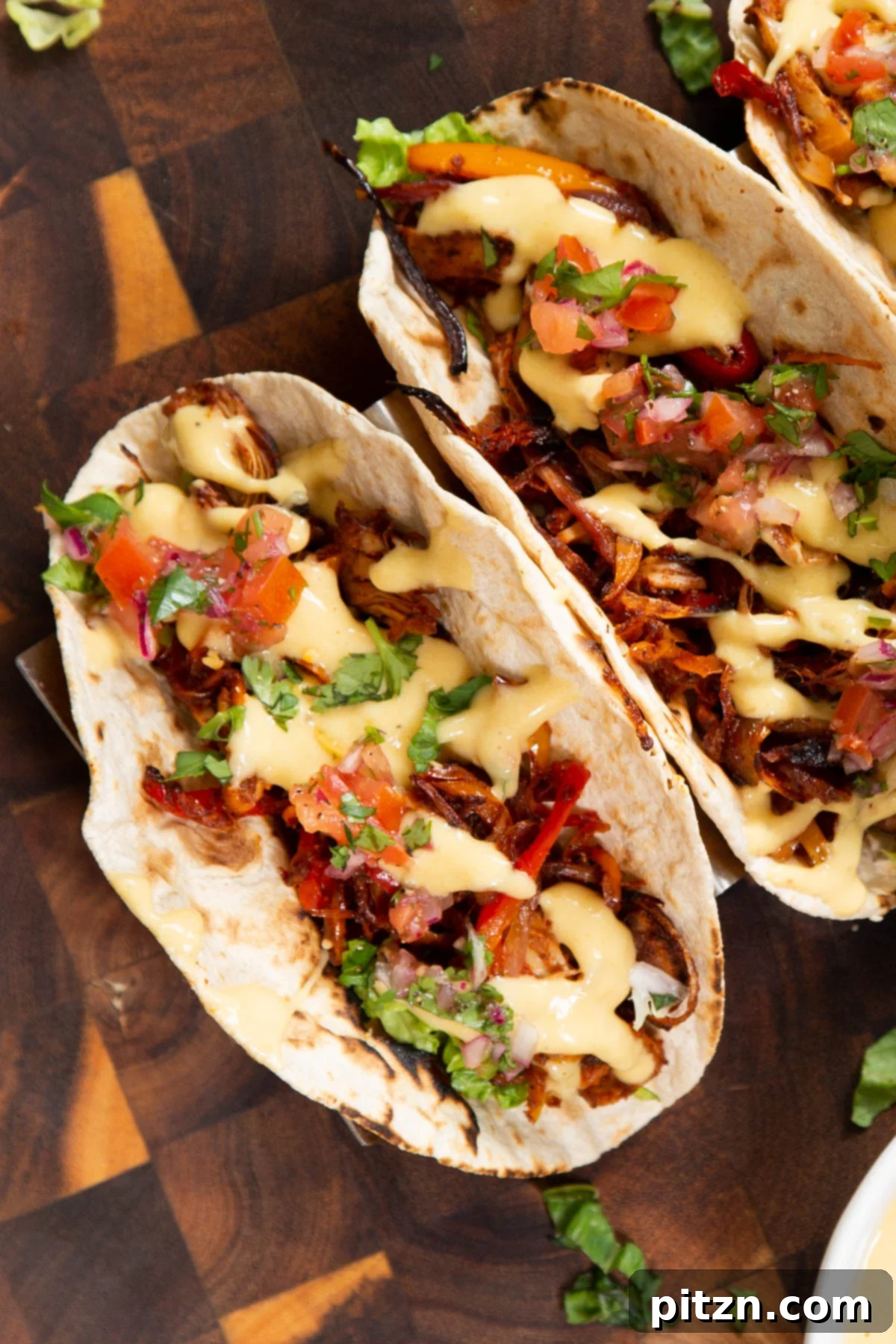 Quick & Easy Vegan Jackfruit Tacos 2 two vegan jackfruit tacos topped with vegan queso and cilantro