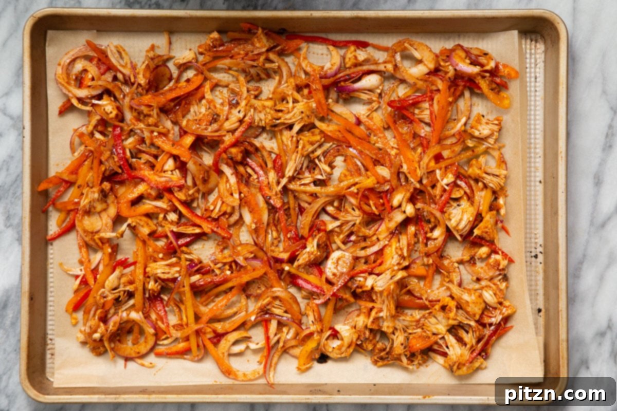 Quick & Easy Vegan Jackfruit Tacos 14 seasoned jackfruit and veggies on a baking sheet