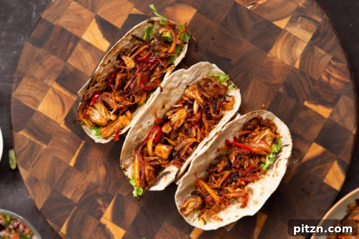 Quick & Easy Vegan Jackfruit Tacos 18 three jackfruit tacos with chopped lettuce and baked marinated vegan taco meat