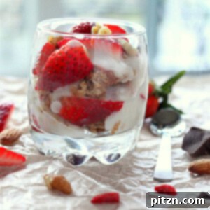 Vegan Gluten-Free Gum-Free Spiced Oat Almond Cake Parfait with Strawberry, Nuts & Goji Berries 5 A glass of Spiced Oat Almond Gluten-free Cake, in Strawberry Nuts Goji berry parfait on a fabric background with pieces of strawberry scattered around