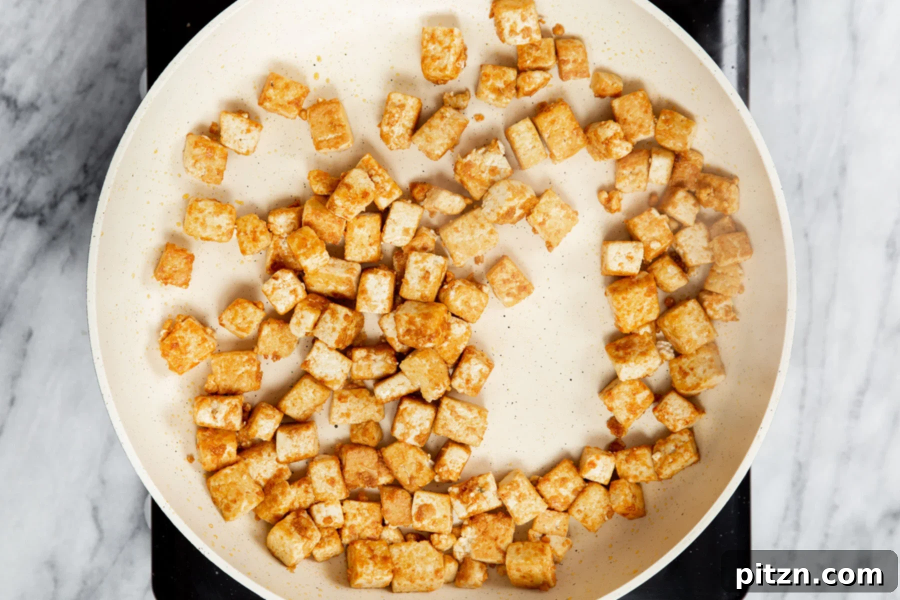 Vegan Tofu Matar 10 pan-fried tofu cubes in a pan