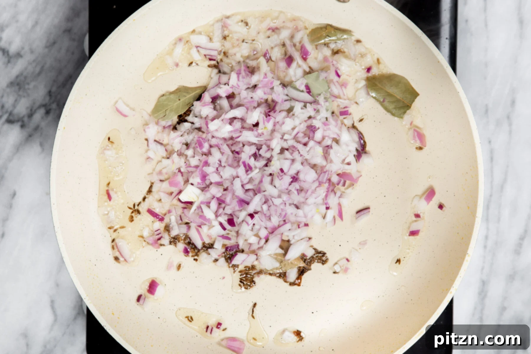 Vegan Tofu Matar 12 onion and spices sauteeing in a pan with oil
