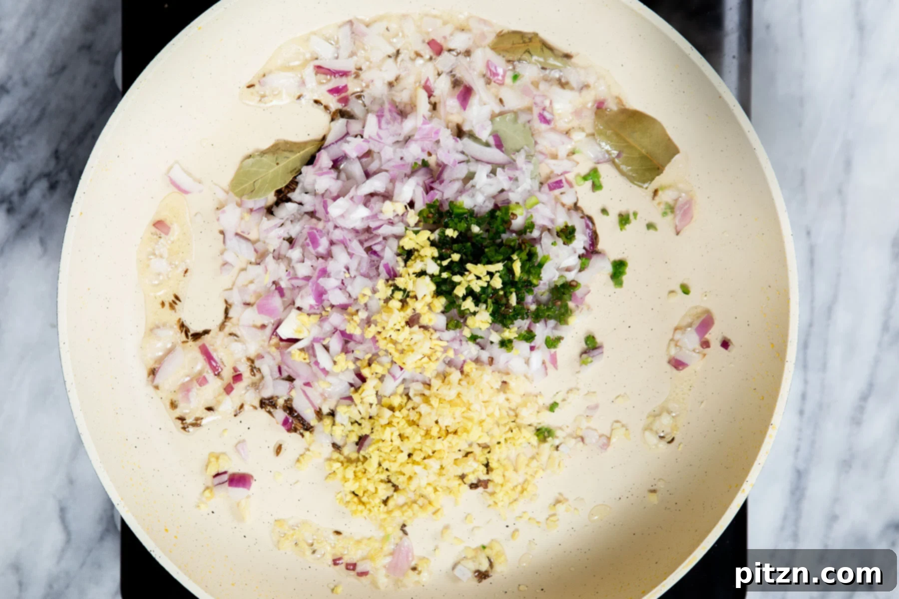 Vegan Tofu Matar 13 minced ginger and diced onion in a sauteeing pan with spices