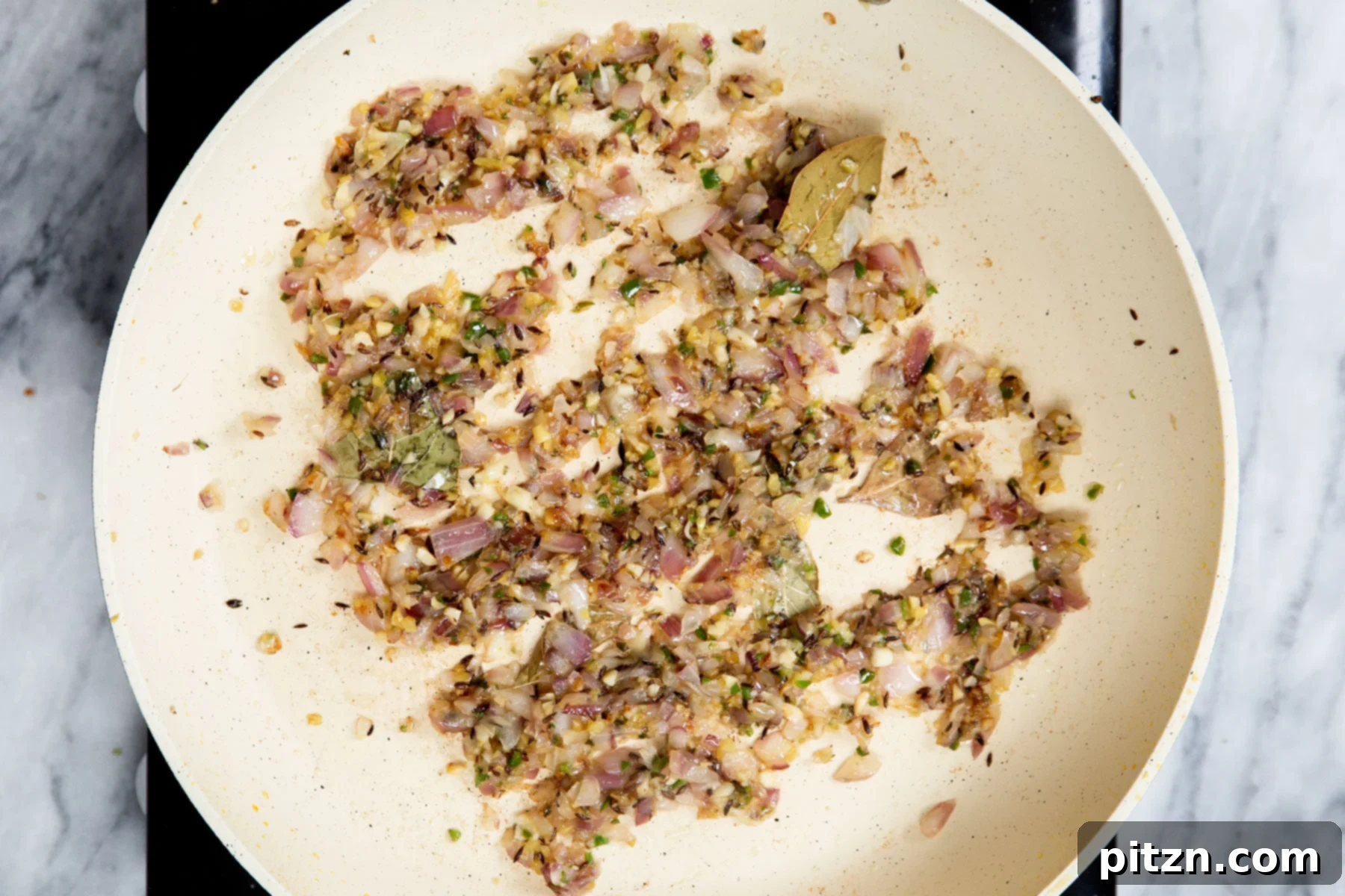 Vegan Tofu Matar 15 onion, spices and ginger frying in a sauteeing pan