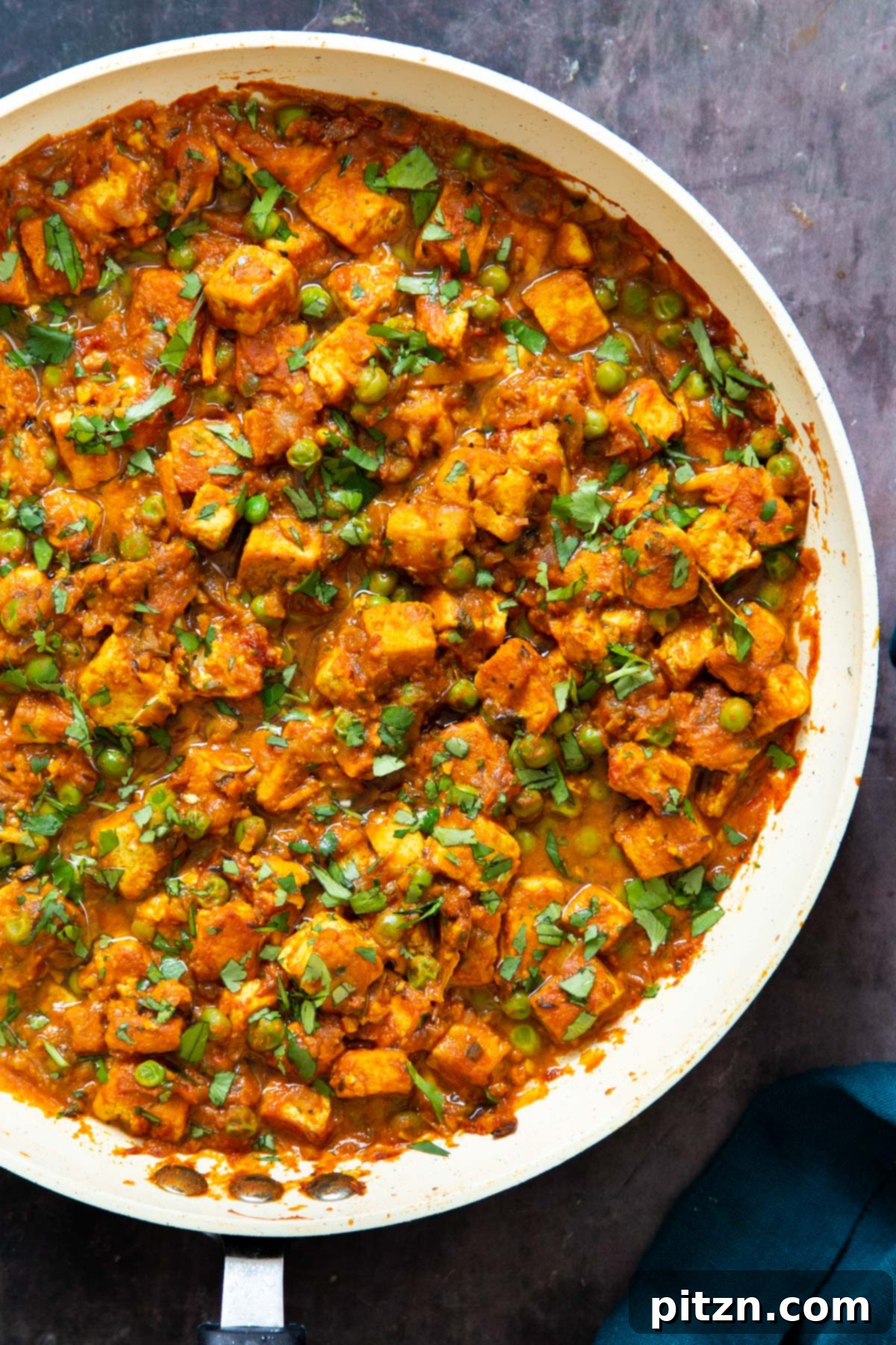 Vegan Tofu Matar 3 vegan tofu matar curry sprinkled with chopped cilantro in a skillet