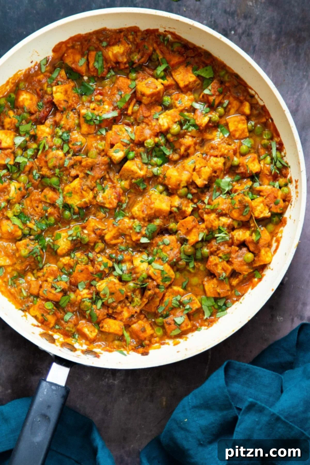 Vegan Tofu Matar 24 Indian tofu curry in a sauteeing pan sprinkled with cilantro