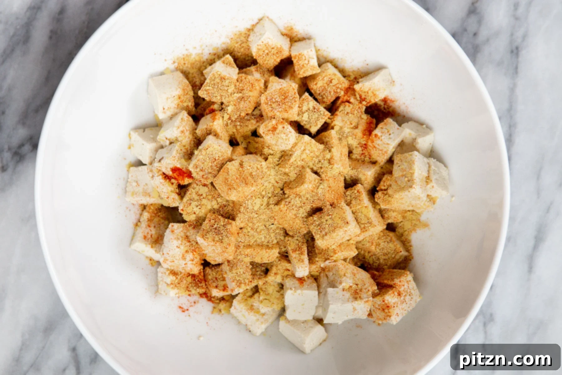 Vegan Tofu Matar 7 seasoned tofu cubes in a small bowl