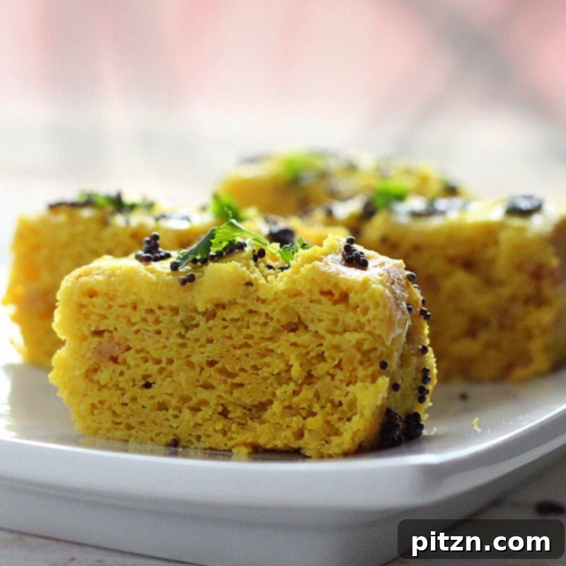 Soft, fluffy Khaman Dhokla slices ready to be served
