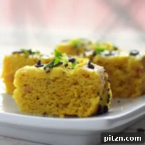Khaman Dhokla Fluffy Savory Steamed Chickpea Cakes Gluten Free Vegan 5 Khaman dhokla slices served on a white plate