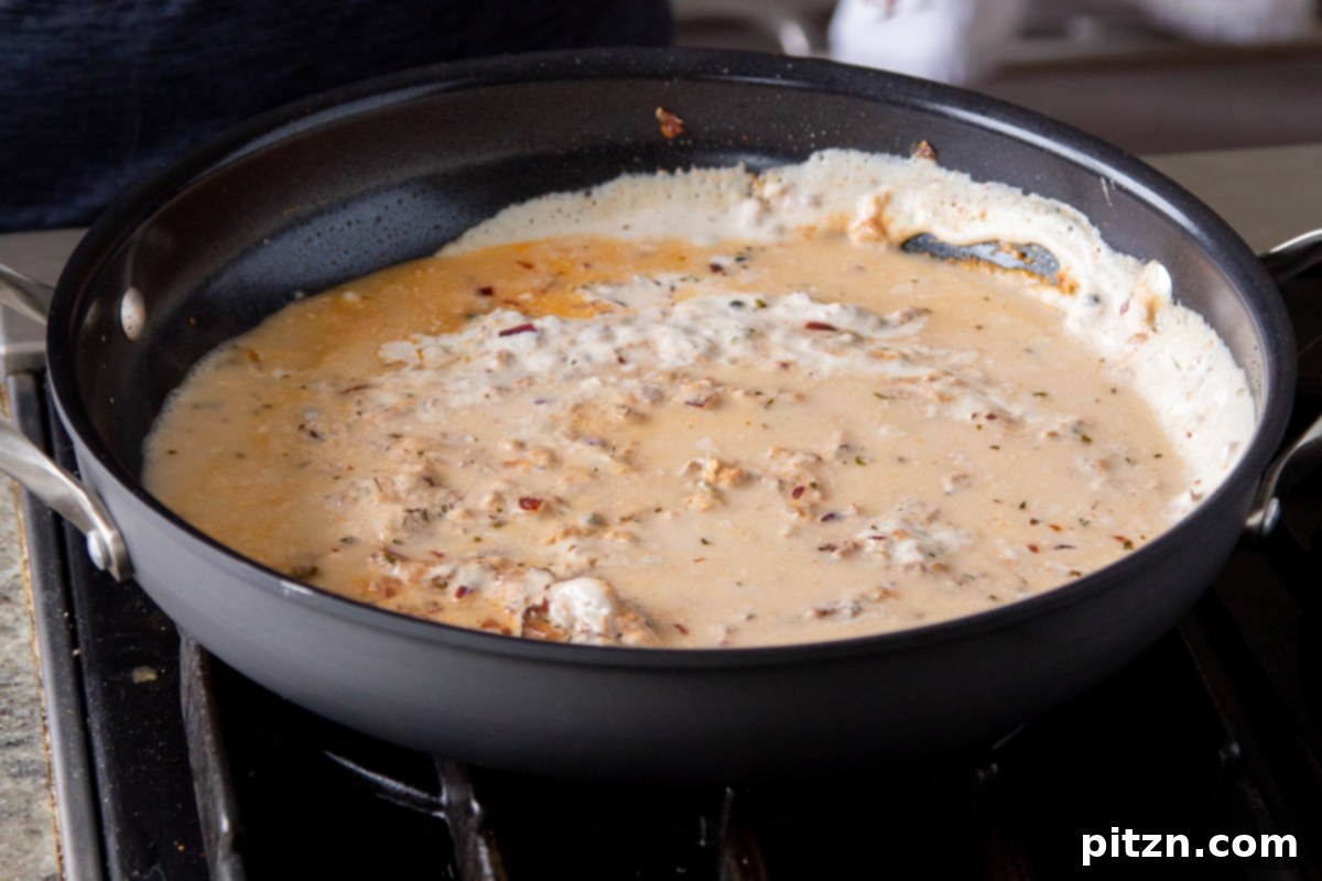 Creamy Fenugreek Tofu and Chickpea Curry 18 Vegan curry sauce gently simmering and thickening in the pan during cooking