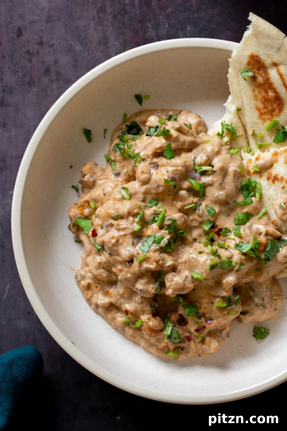 Creamy Fenugreek Tofu and Chickpea Curry 3 Vegan Kasuri Malai Murg elegantly plated with soft, fresh naan bread