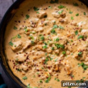 Creamy Fenugreek Tofu and Chickpea Curry 4 vegan kasuri malai murg in the pan, after cooking with fresh herbs sprinkled on top