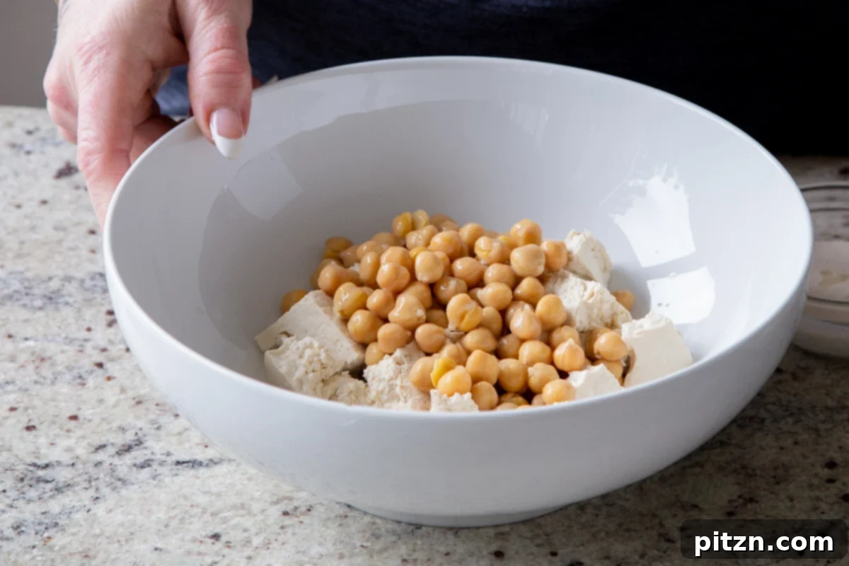 Creamy Fenugreek Tofu and Chickpea Curry 6 Torn tofu and chickpeas in a bowl, ready for seasoning and marination