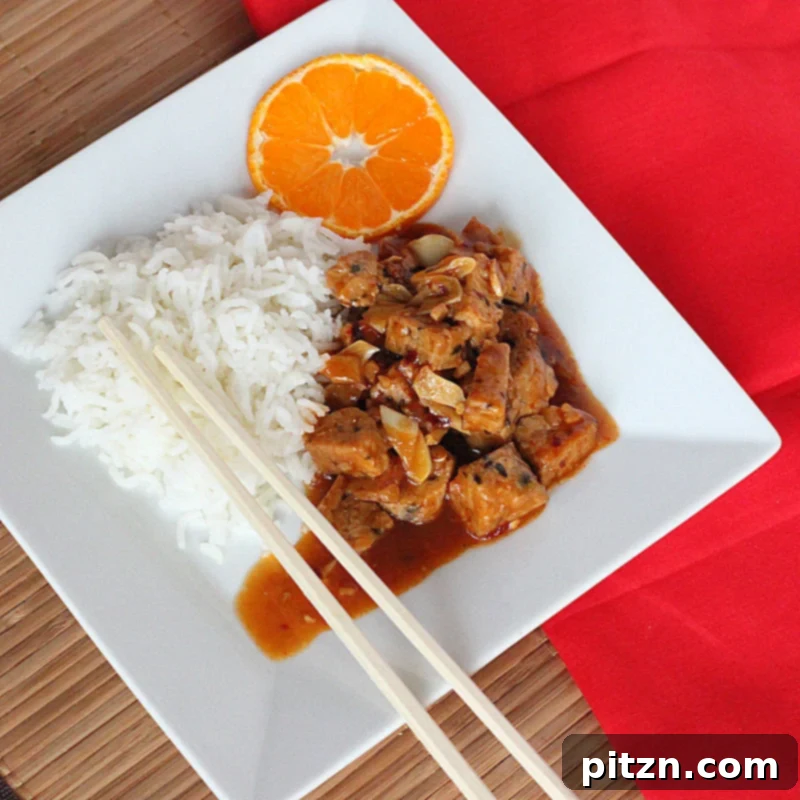 Plated General Tso's Tempeh with vibrant orange sauce