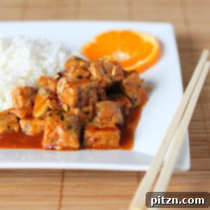 General Tso's tempeh served on a white plate with rice