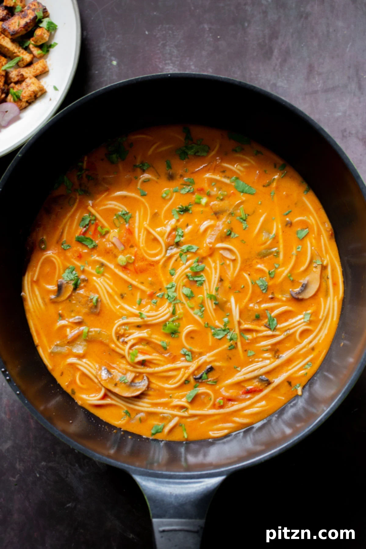 Decadent Vegan Butter Chicken Ramen 3 Butter ramen in a wok, freshly cooked and ready for garnishes