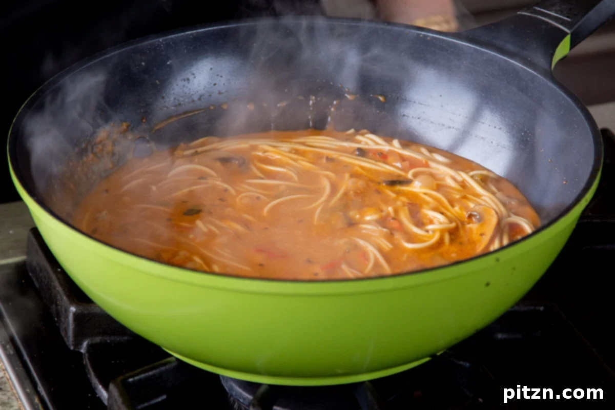 Decadent Vegan Butter Chicken Ramen 20 Cooked Vegan Butter Chicken Ramen noodles and broth in a wok, perfectly done and ready to serve.
