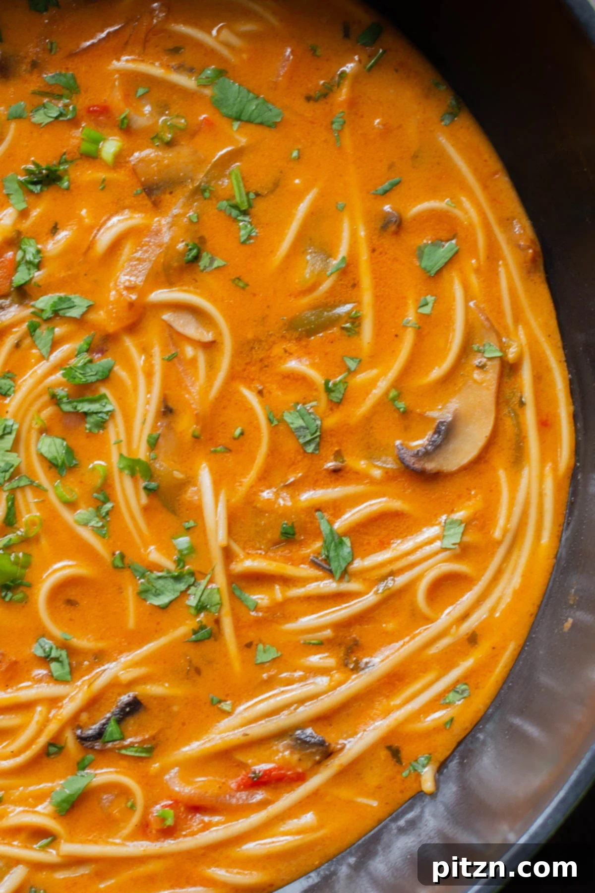 Decadent Vegan Butter Chicken Ramen 4 Close-up of creamy vegan butter ramen simmering in a wok, showcasing its rich texture
