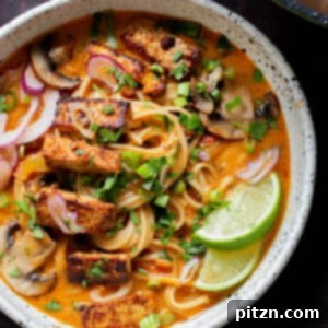 bowl of butter ramen with tofu and a lime wedge