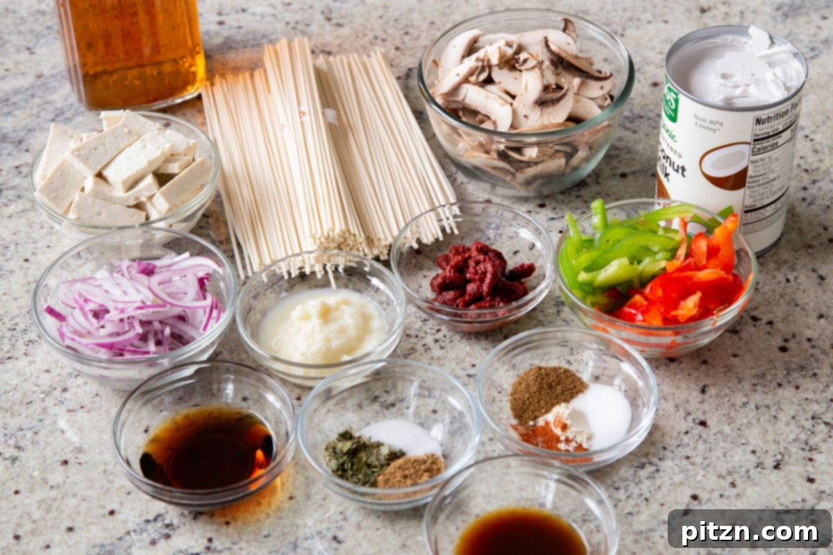 Decadent Vegan Butter Chicken Ramen 7 Assortment of fresh ingredients for Vegan Butter Chicken Ramen laid out on a kitchen counter, ready for preparation.