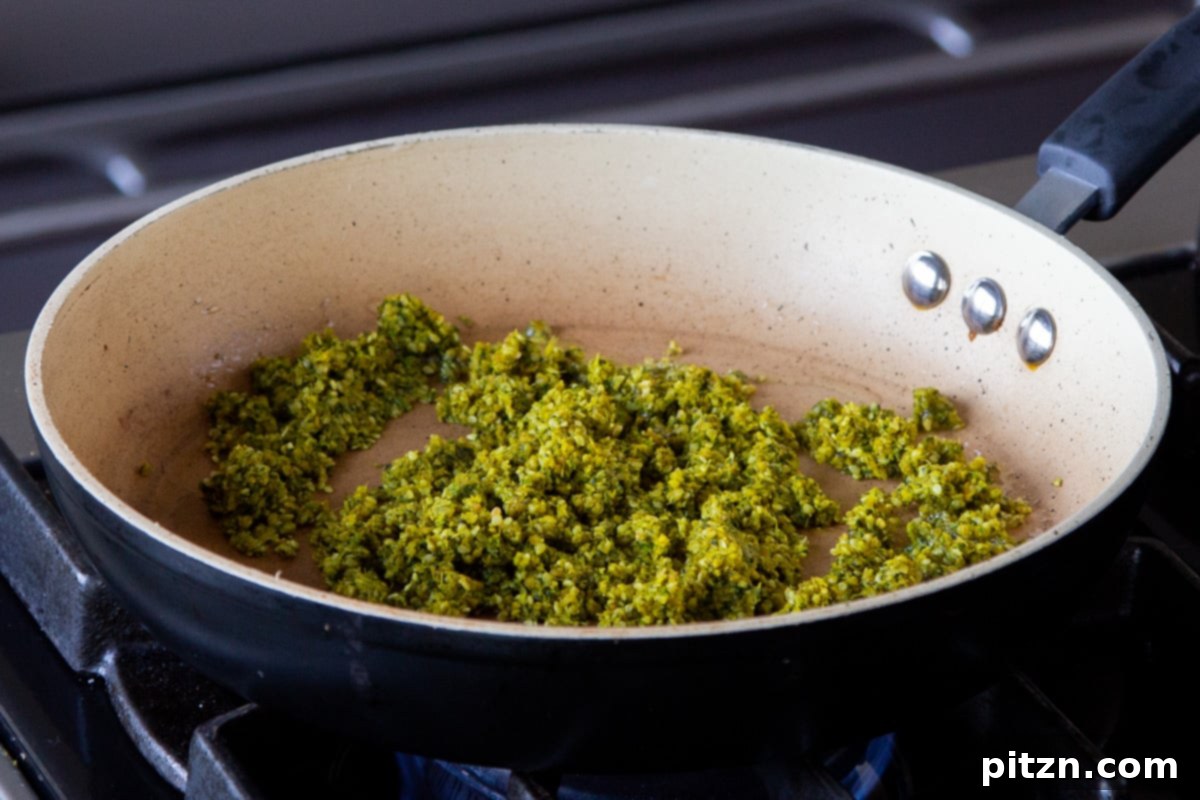 The aromatic peanut-sesame seed-spice mixture gently roasting in a hot frying pan.