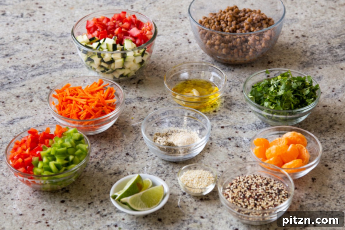 Effortless Lentil Quinoa Medley 11 Bowls of prepped lentil, quinoa, and various salad ingredients, alongside dressing components, neatly arranged on a kitchen counter.