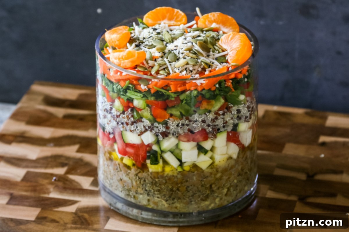 Effortless Lentil Quinoa Medley 22 A perfectly layered lentil quinoa salad showcased in a large glass jar, ready for storage or transport.