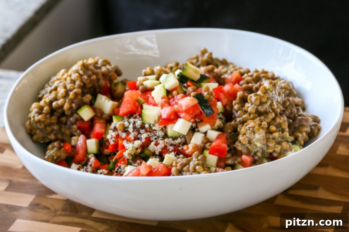 Effortless Lentil Quinoa Medley 24 Lentils, quinoa, and various chopped vegetables arranged in a mixing bowl, prior to being tossed with dressing.