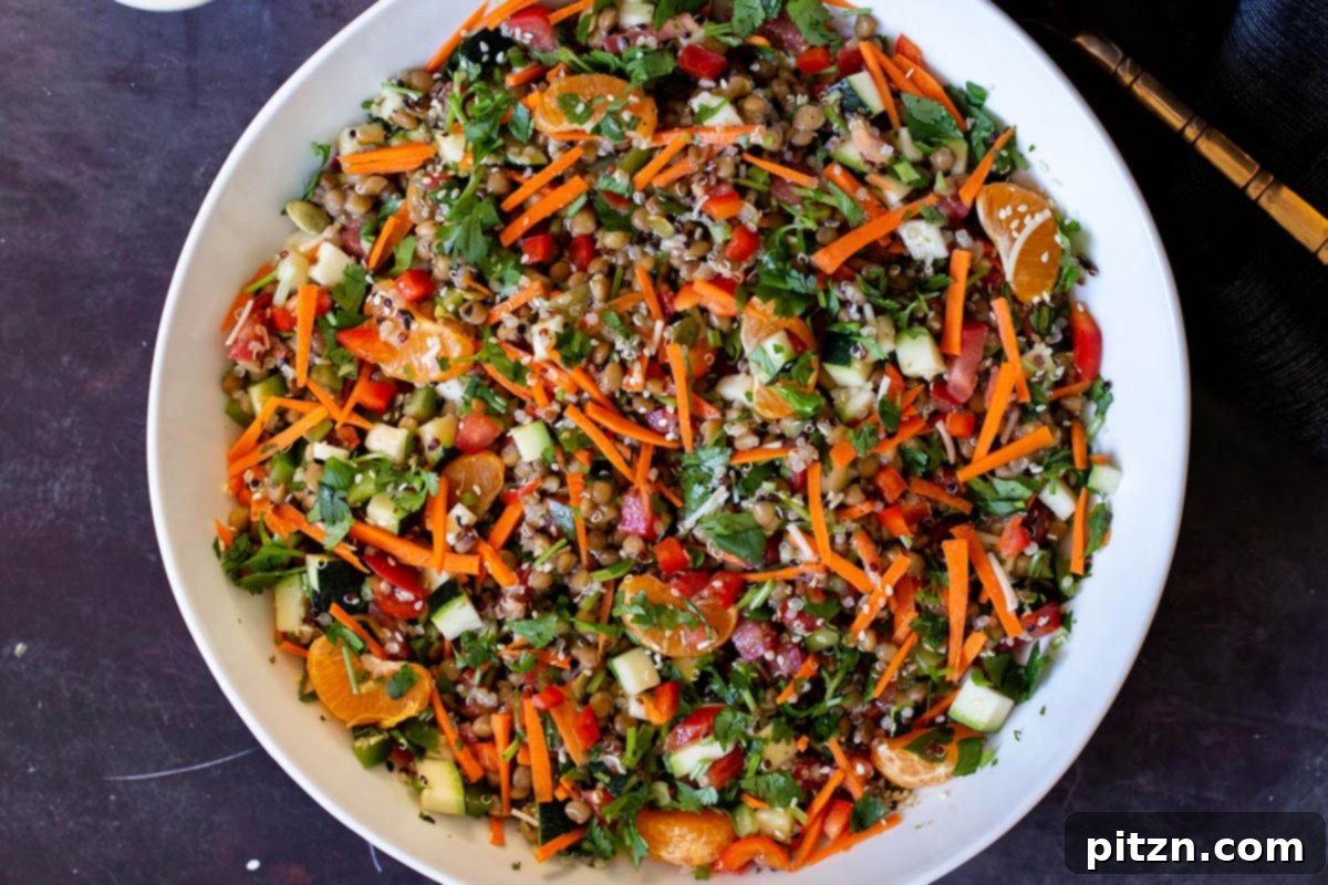 Effortless Lentil Quinoa Medley 26 A large serving bowl brimming with a vibrant lentil quinoa salad, showcasing its fresh, colorful vegetables and satisfying texture.