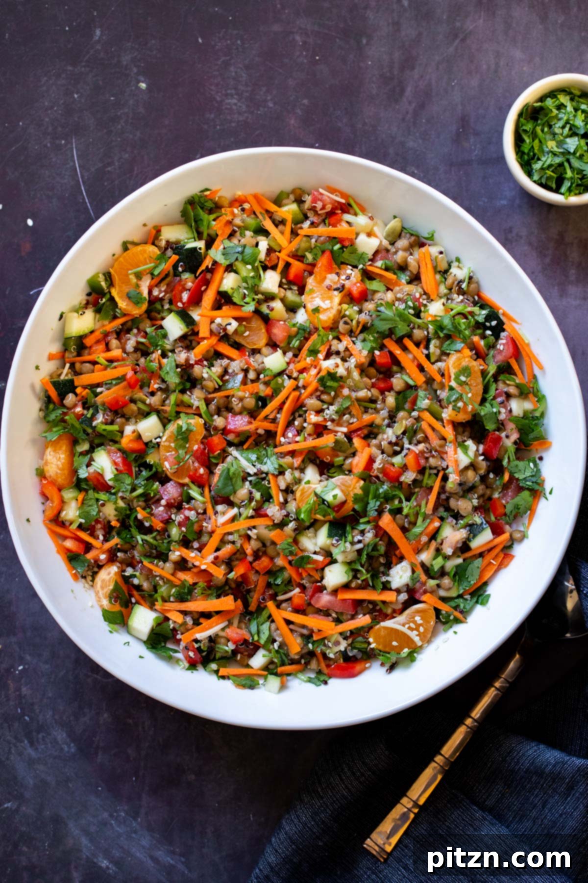 Effortless Lentil Quinoa Medley 4 A large bowl filled with vibrant lentil quinoa salad, showcasing a mix of colorful vegetables and a zesty dressing.