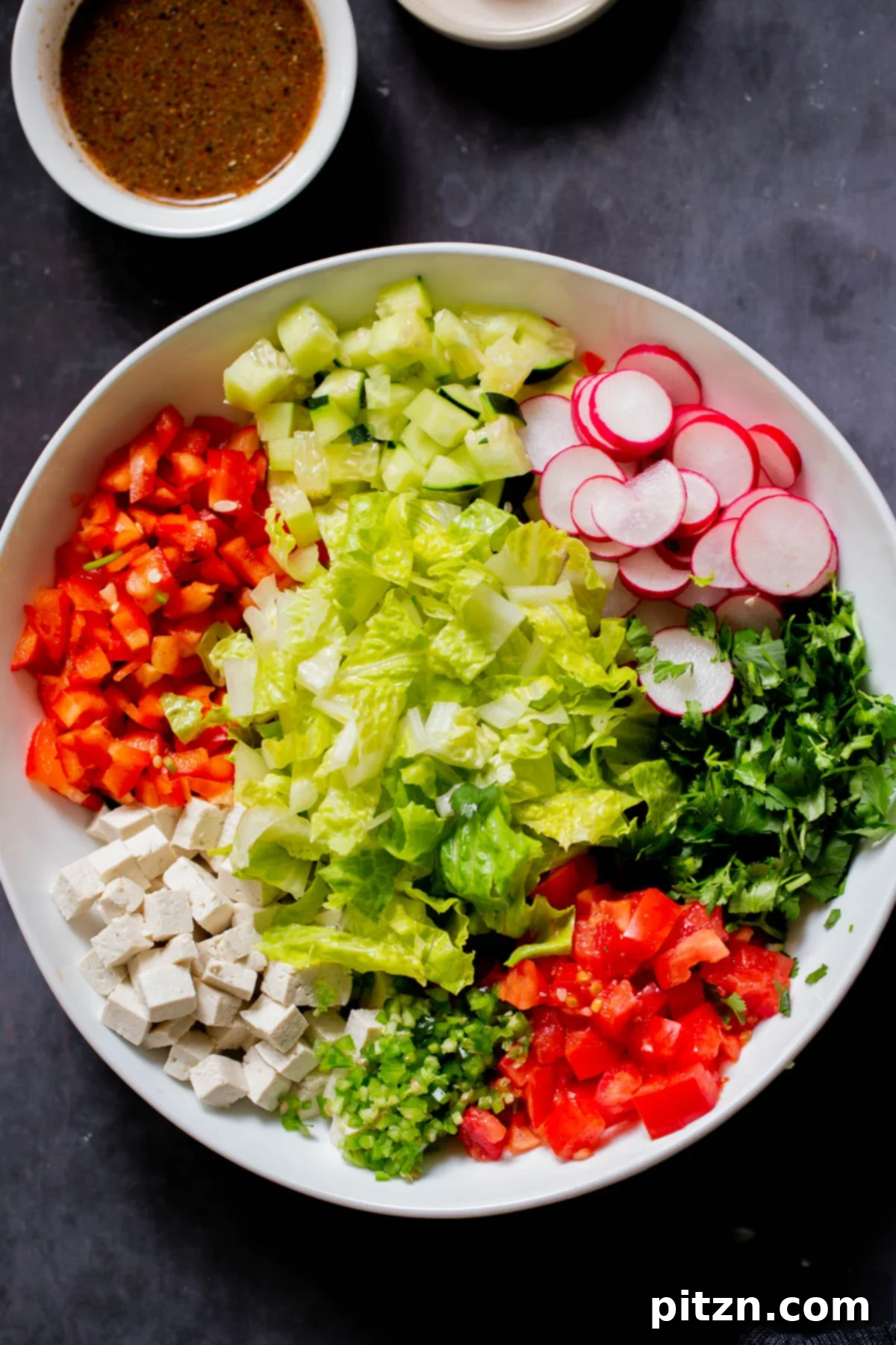 Wholesome Chaat Masala Chopped Salad 3 tofu, cilantro, and veggies in the mixing bowl before mixing