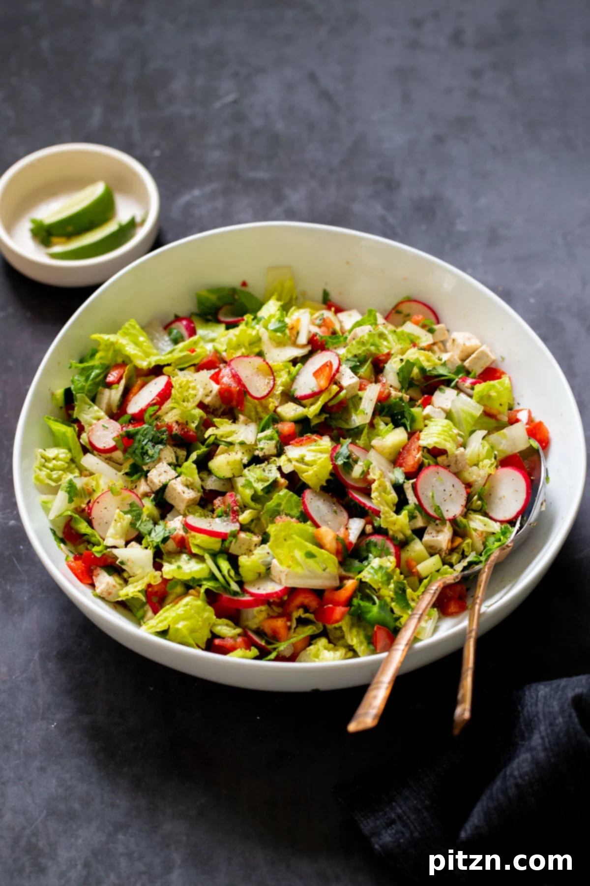 Wholesome Chaat Masala Chopped Salad 4 chaat masala salad in the mixing bowl with serving spoons