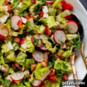 close-up of chaat masala salad in the mixing bowl with serving spoons