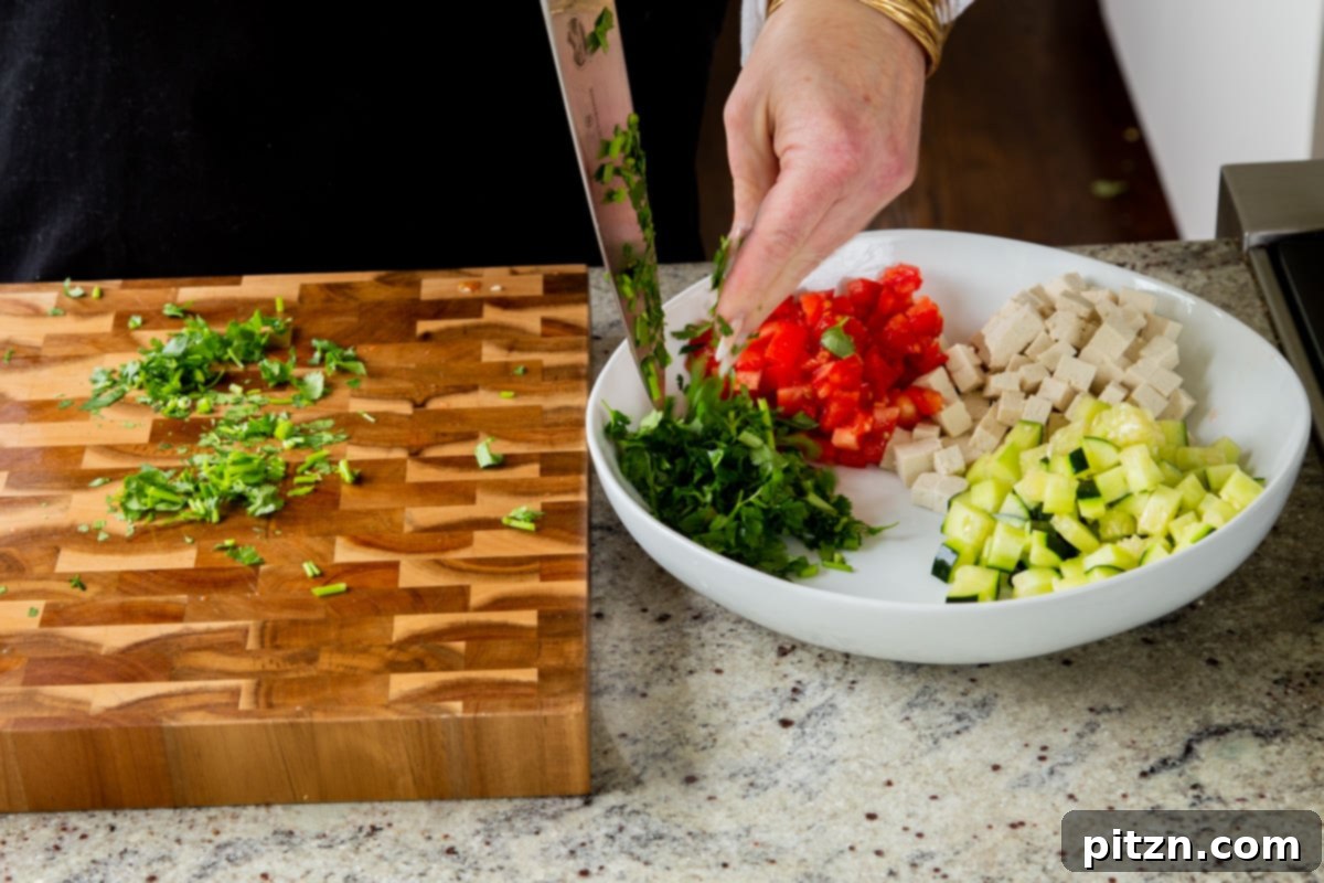 Wholesome Chaat Masala Chopped Salad 7 adding cilantro to the salad bowl