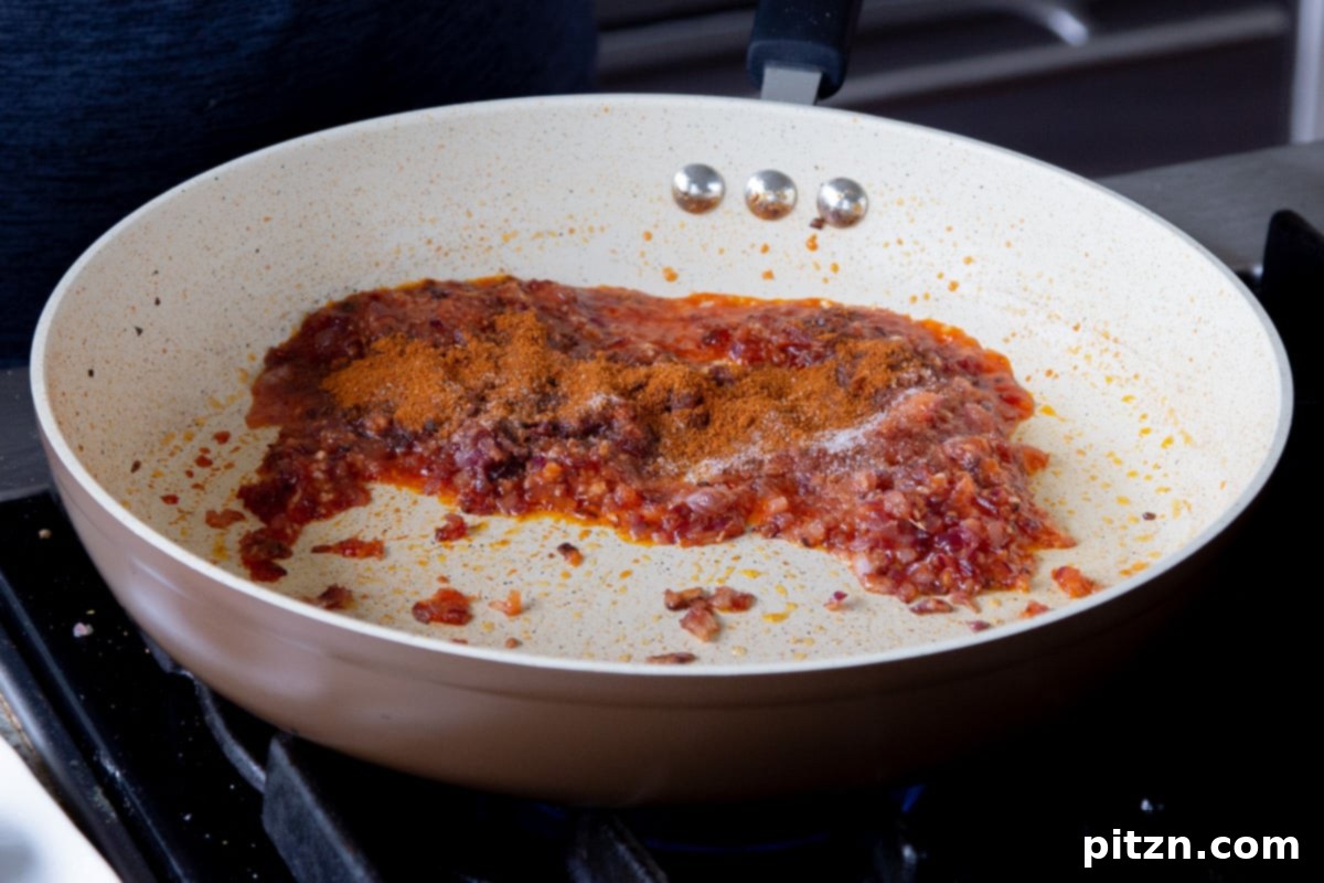 adding cajun spices to the cooked onion mixture
