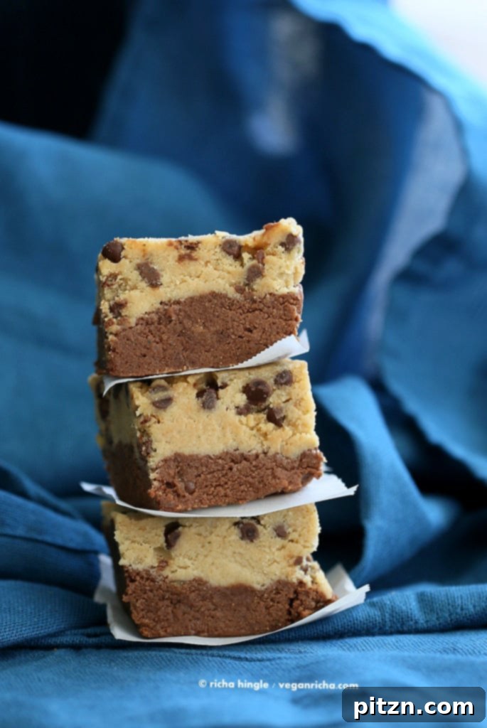 No Bake Vegan Cookie Dough Brownies Gluten Free High Protein 3 Close-up of a stack of Vegan Cookie Dough Brownies on a plate, showcasing the fudgy brownie base and the creamy chocolate chip cookie dough topping. This gluten-free and dairy-free dessert is perfect for health-conscious foodies.