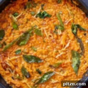 A pan full of delicious vegan dalcha, a hearty and flavorful Indian lentil stew.