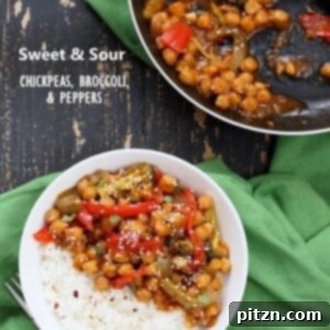 A colorful skillet of sweet and sour chickpeas, bell peppers, and broccoli, vibrant and ready to be served.