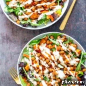 Two inviting bowls of spicy sweet potato chickpea salad with creamy tahini dressing, perfect for a healthy lunch.