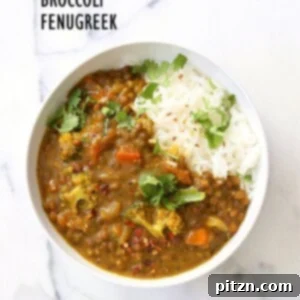 A warm bowl of brown lentil soup with florets of broccoli, garnished with fenugreek seeds and black pepper, perfect for a healing winter meal.
