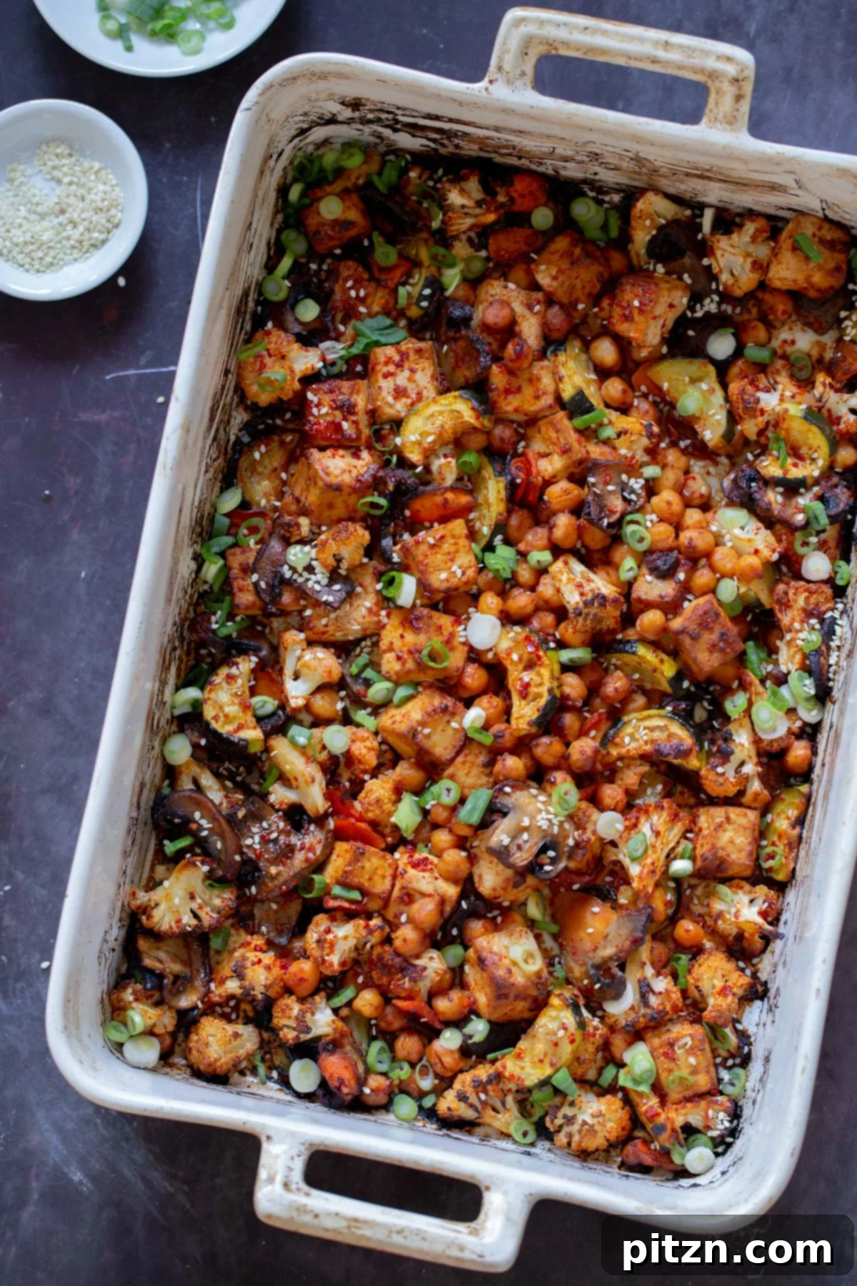 Gochujang tofu and mixed vegetables cooked on a sheet pan, ready to be served.