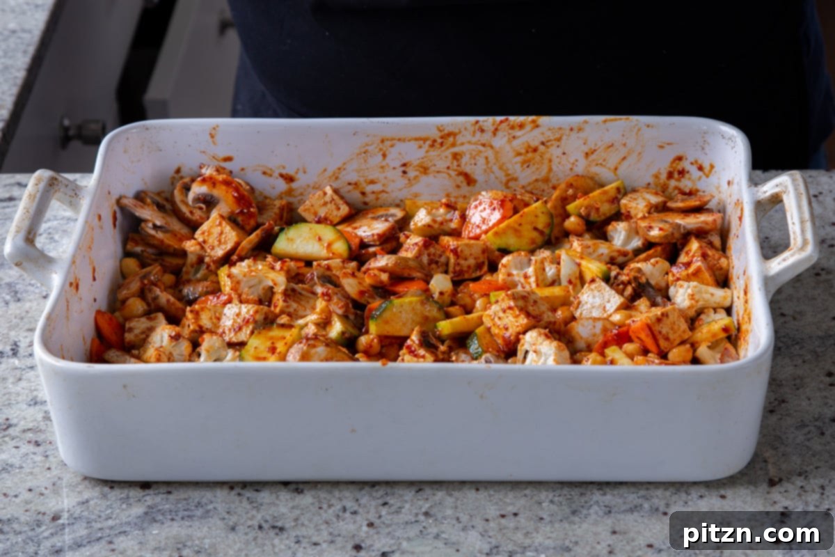 Tofu and vegetables thoroughly tossed and coated in the Gochujang marinade, ready for baking.