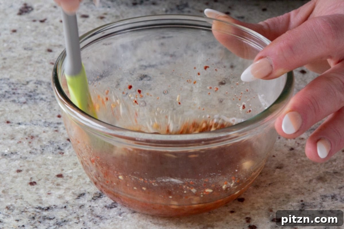 Mixing the ingredients for the zesty Gochugaru dressing in a small bowl.