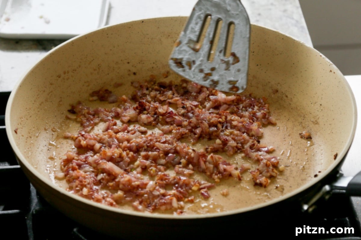 Effortless Rosé Beans for All 8 Sautéed golden-brown onions and garlic in the pan after cooking.