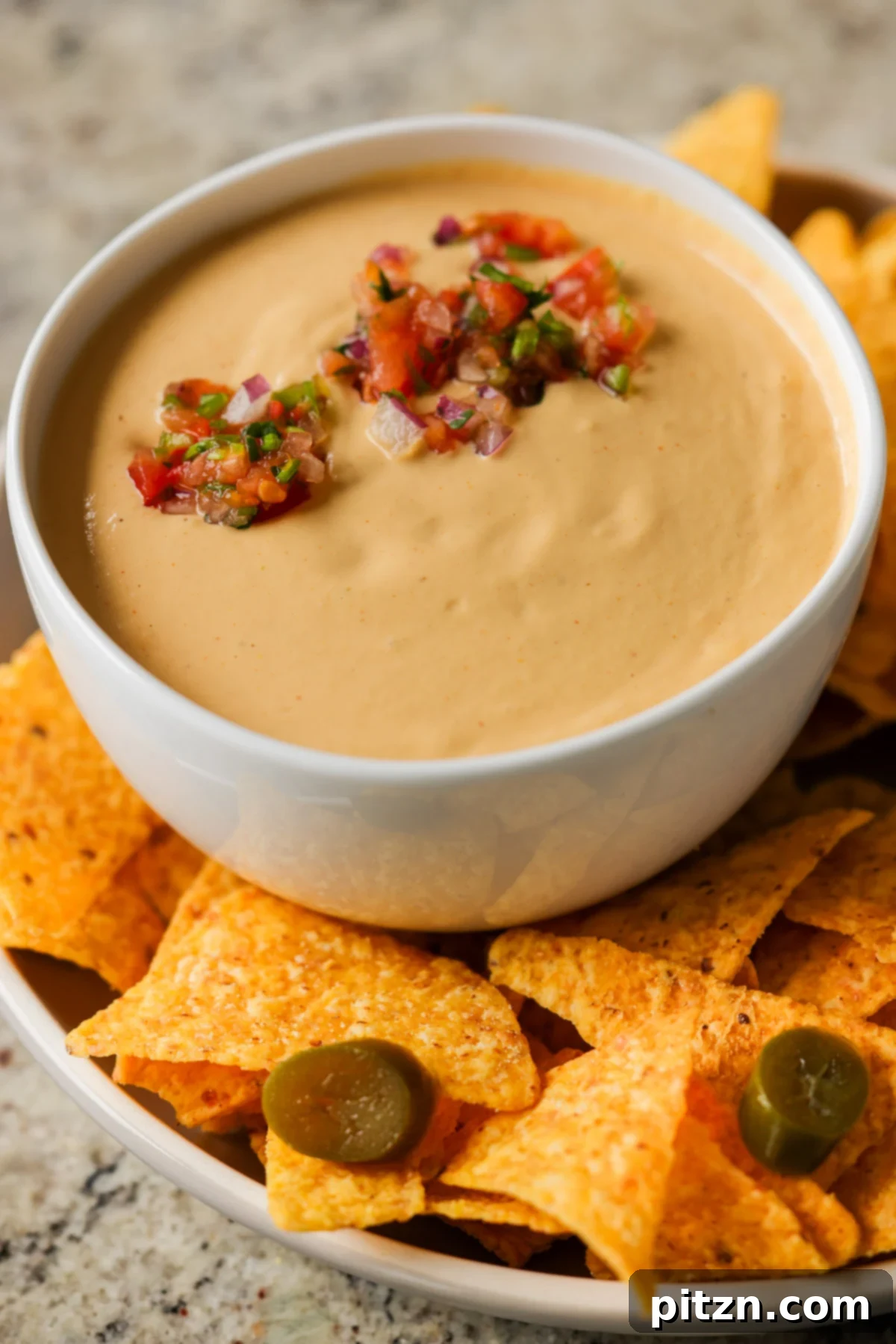 Amazing Cashew Nacho Cheese Gluten Free Oil Free Soy Free Choice 2 Creamy cashew nacho cheese in a serving bowl topped with fresh, vibrant salsa, ready for dipping