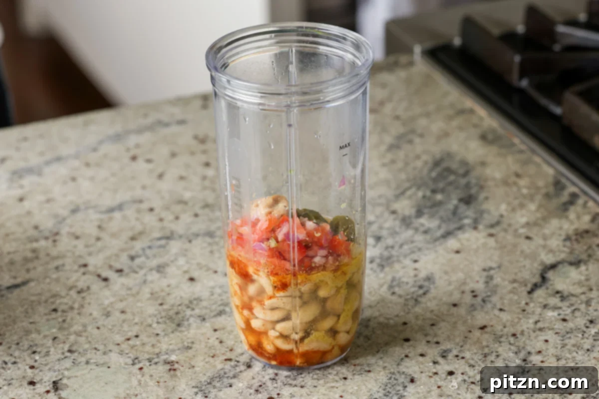 Amazing Cashew Nacho Cheese Gluten Free Oil Free Soy Free Choice 8 Raw cashews, nutritional yeast, miso, and various spices meticulously placed in a blender jug, ready for the blending process