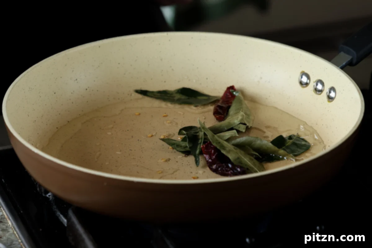 Tofu Kondattam: Crispy & Spicy South Indian Tofu 14 Roasting dried red chilies and curry leaves in hot oil in a skillet
