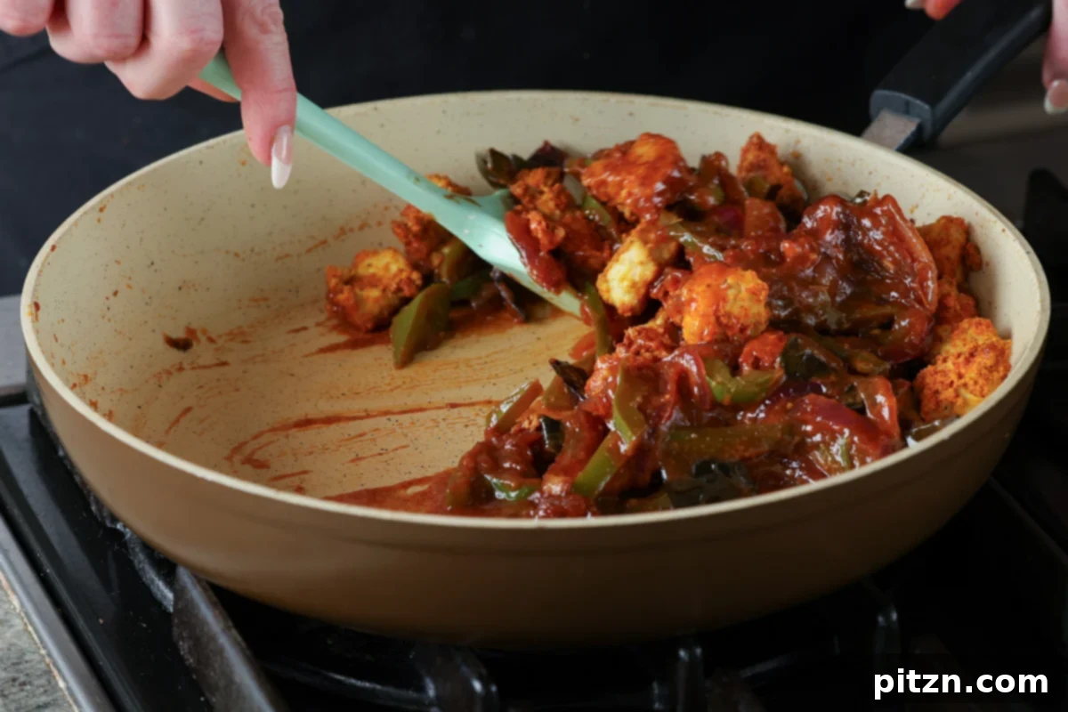 Tofu Kondattam: Crispy & Spicy South Indian Tofu 23 Mixing the tofu thoroughly into the rich, red Kondattam sauce until well-coated