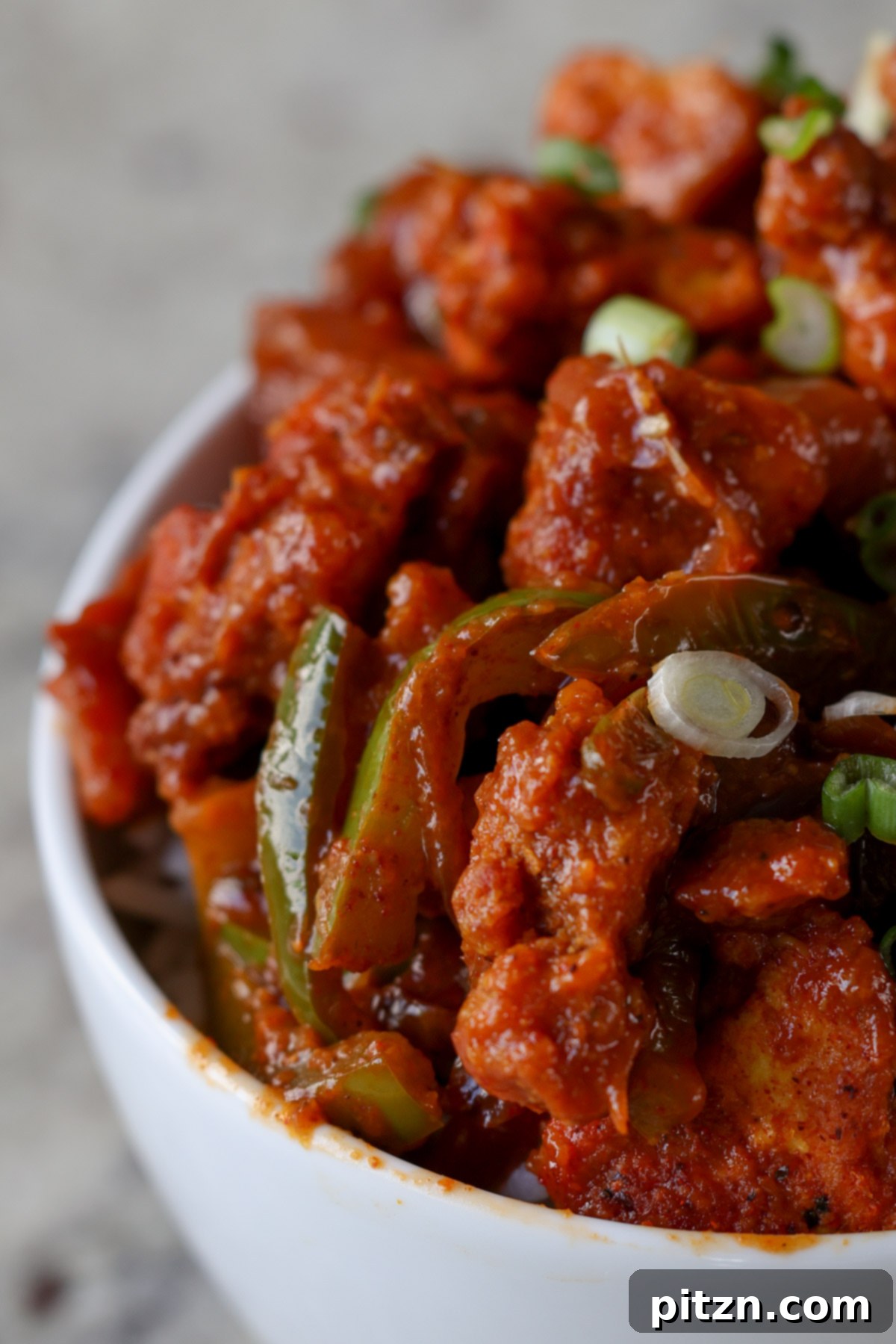 Tofu Kondattam: Crispy & Spicy South Indian Tofu 4 Extreme close-up view of spicy Tofu Kondattam with rice, highlighting crispy tofu pieces