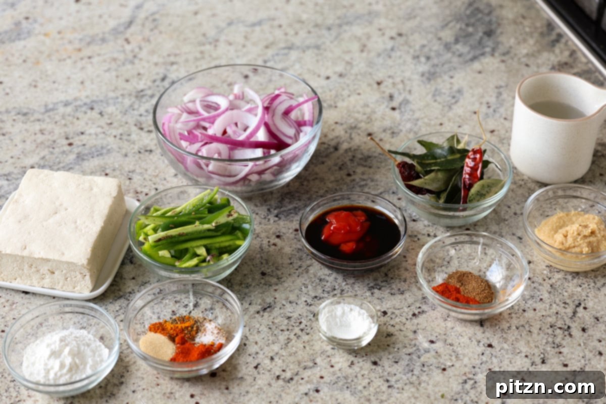Tofu Kondattam: Crispy & Spicy South Indian Tofu 7 Assortment of fresh tofu, vegetables, and spices laid out on a kitchen counter, ready for Tofu Kondattam preparation